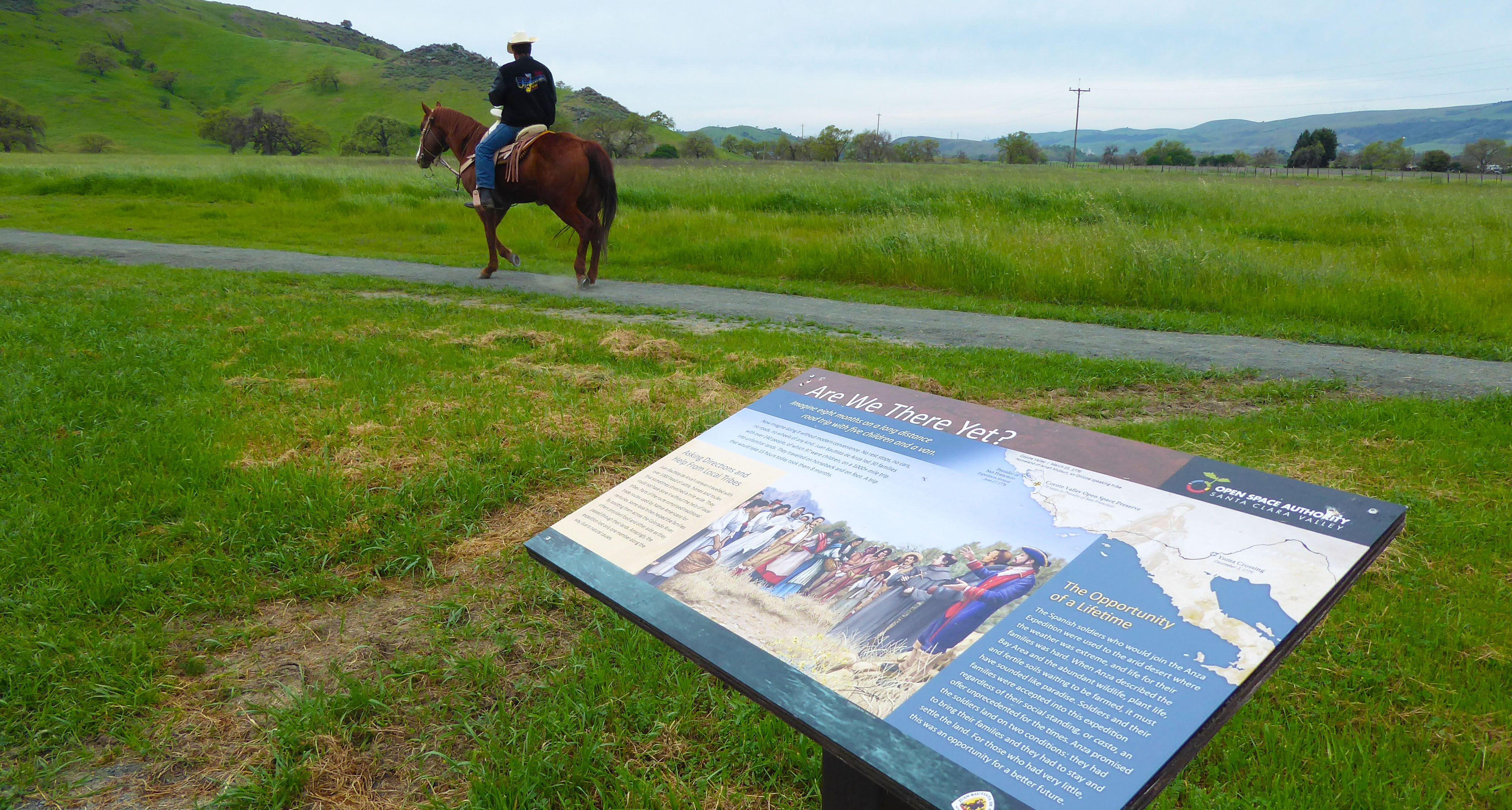 Interpretive panel on the De Anza Expedition, horseback rider in background