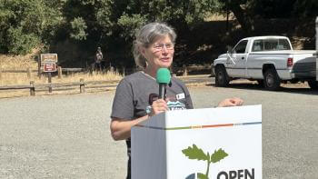 Janet McBride stands at Open Space Authority podium