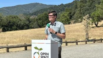 Todd Lofgren standing at Open Space Authority podium