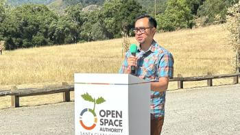 Virgilio Cuasay standing at Open Space Authority podium