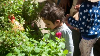 young girl smelling flowers