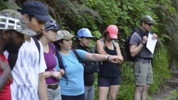 Group of people standing on a trail 