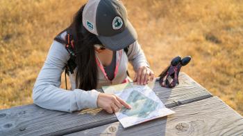 Hiker looking at a map at a rest stop table