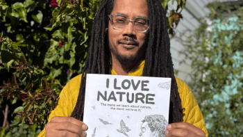 Robert Liu-Trujillo holds up the "I Love Nature" Nature Activity Book