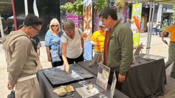 Visitors of an Open Space Authority learn about the Coyote Valley landscape with the help of a 3D map.