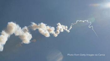 A rocket's smoke trails leave behind cloud-like puffs that sit against a blue sky.