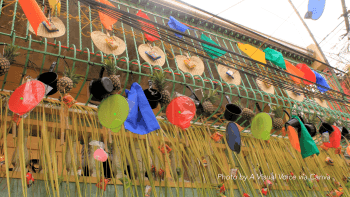 A photo of a housing complex decorated in bright colors, hats and pineapple in honor of Pihayas Festival.