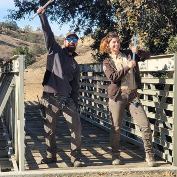 Two OSA staff members celebrate the completion of renovating a bridge at Coyote Valley OSP