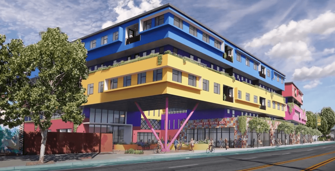 An architectural rendering of a colorful pink, purple, yellow, and blue building on a street lined with shady trees, where people walk and ride their bikes
