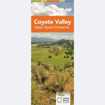 The cover of a brochure with the title Coyote Valley Open Space Preserve in an orange banner over a landscape photo looking over a green valley