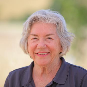 A portrait of Director Margie Matthews standing outside in Coyote Valley