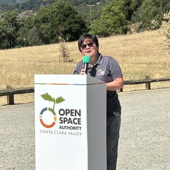 Andrea Mackenzie stands at Open Space Authority podium