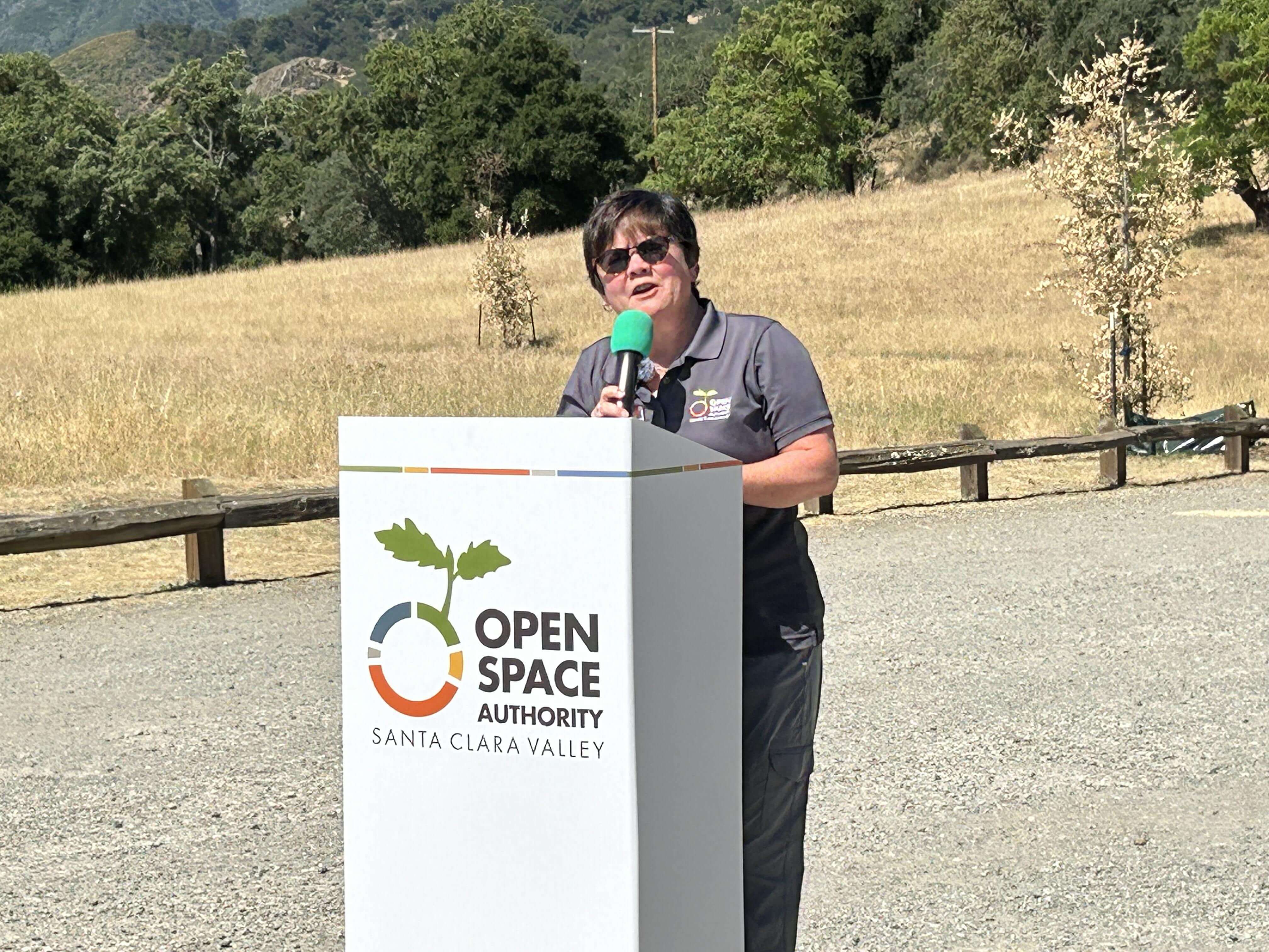 Andrea Mackenzie stands at Open Space Authority podium