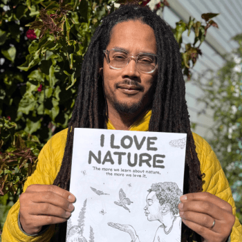 Robert Liu-Trujillo holds up the "I Love Nature" Nature Activity Book