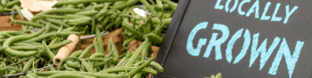 Green beans sit on a table at a local farmer's market