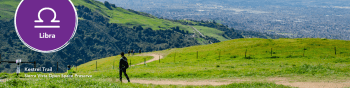 Kestrel Trail with green mountains and vast view. Libra symbol in the left corner.