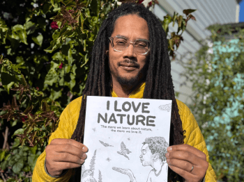 Robert Liu-Trujillo holds up the "I Love Nature" Nature Activity Book