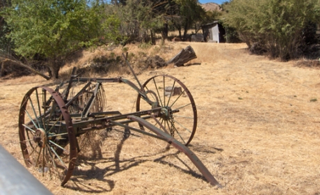 Historic farm equipment on brown grass field at Santa Teresa County Historic Park