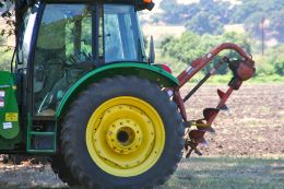 Close-up of green tractor with yellow and black wheel