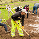 Group of volunteers working on muddy trail