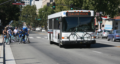 Busy San Jose street with cars, bus, and cyclists 