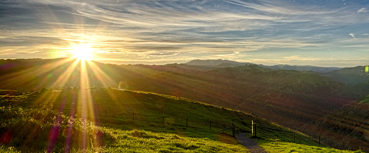Sun rising over Sierra Vista's green hills
